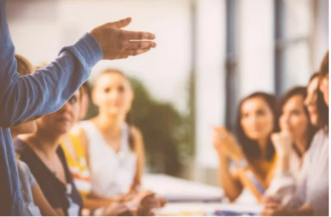 group of adults listening to a teacher